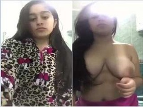 Watch as a stunning girl strips down and flaunts her ample bosom