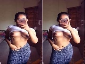 A beautiful girl snaps pictures of her breasts for her partner