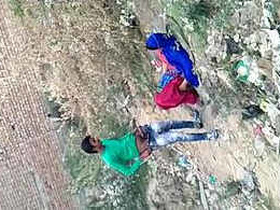 Desi woman shouts in pleasure as she has sex in the bushes, recorded by another man