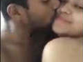 College students share a passionate kiss in bed