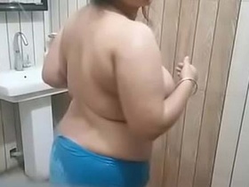 Watch a curvy bhabha show off her big breasts in the bathroom