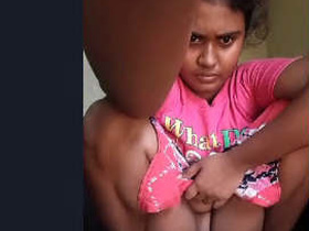 A woman exposing her shaved pussy while urinating
