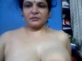 Watch a busty Indian bhabhi flaunt her big tits and perky nipples in this hot video