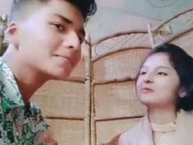 Cute couple enjoys romantic kissing in the outdoor restaurant