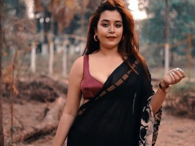 Model Rimpi poses seductively for a photo shoot with her ample bosom on display