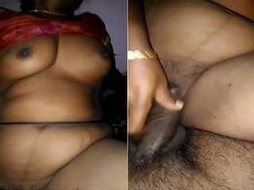Aunty fucker enjoys a hard cock ride in Tamil video