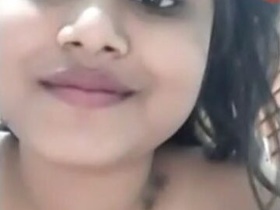 Young girl flaunts her perky breasts in a seductive manner