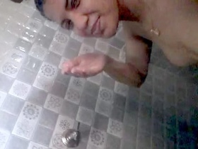 Desi girl records herself while bathing in selfie video